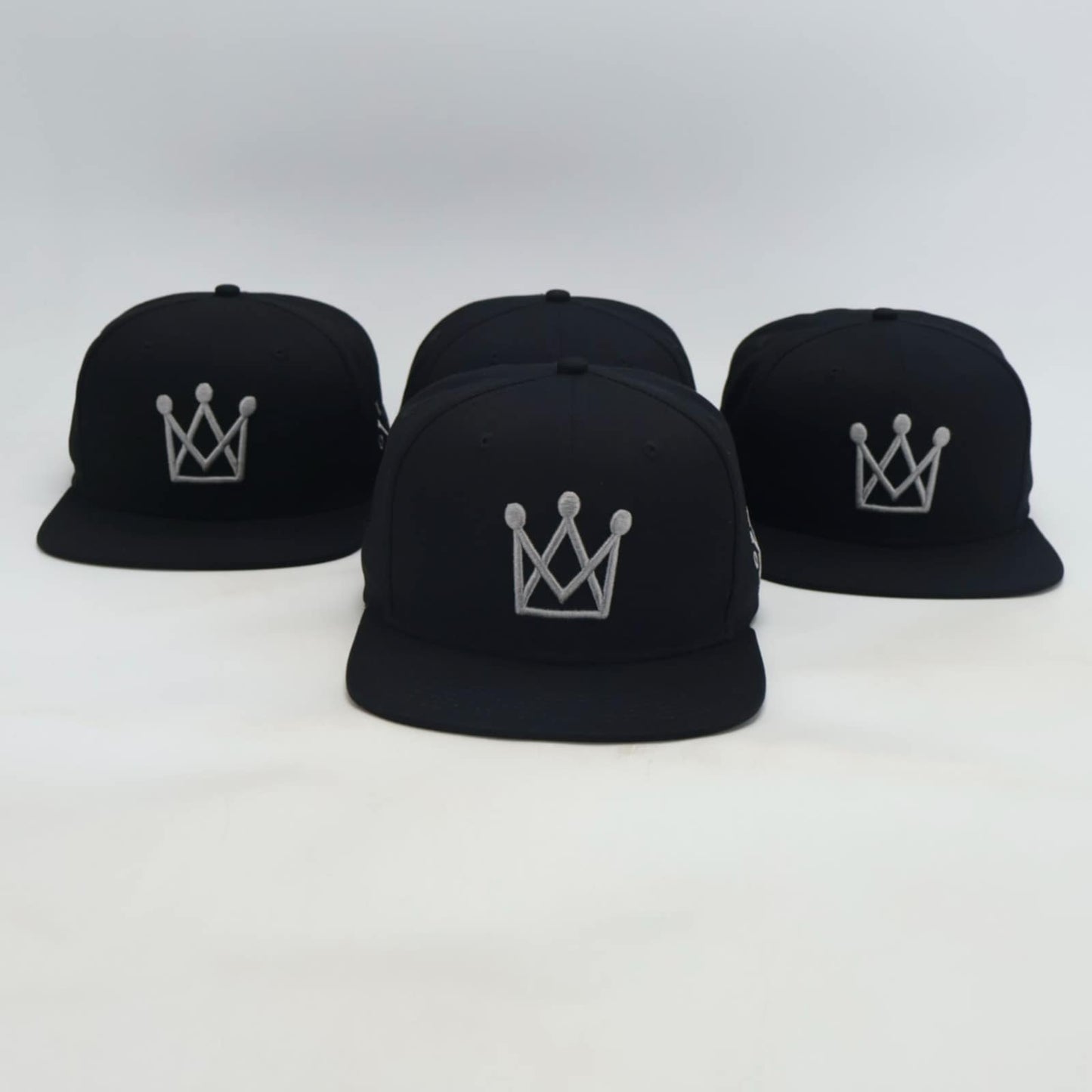 Black Snapback hat with grey crown logo - front view