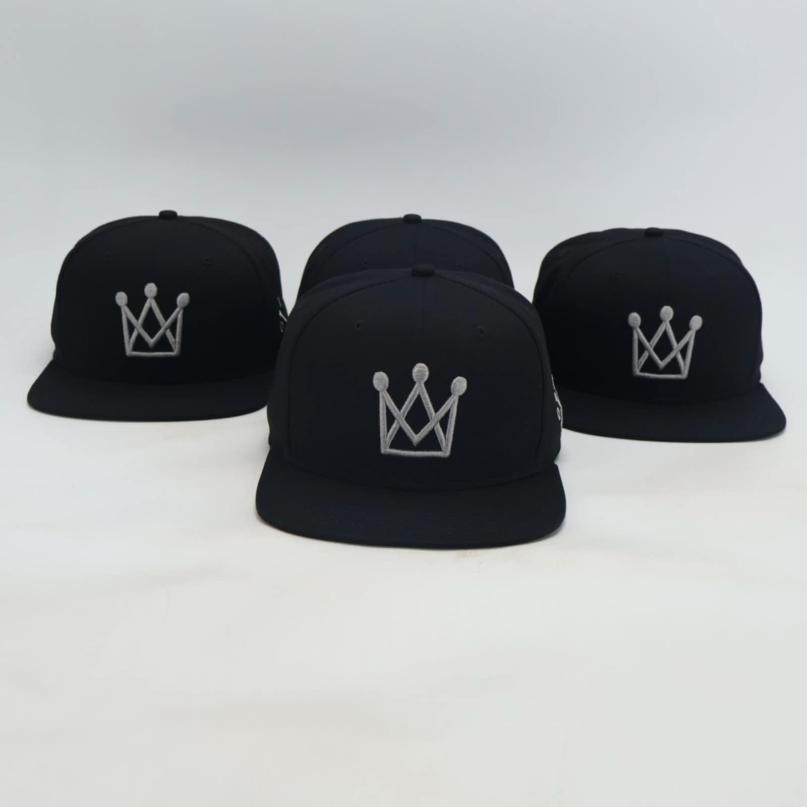 Black Snapback hat with grey crown logo - front view