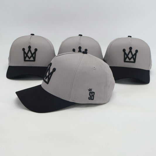Grey and black snapback hat with embroidered crown logo side view