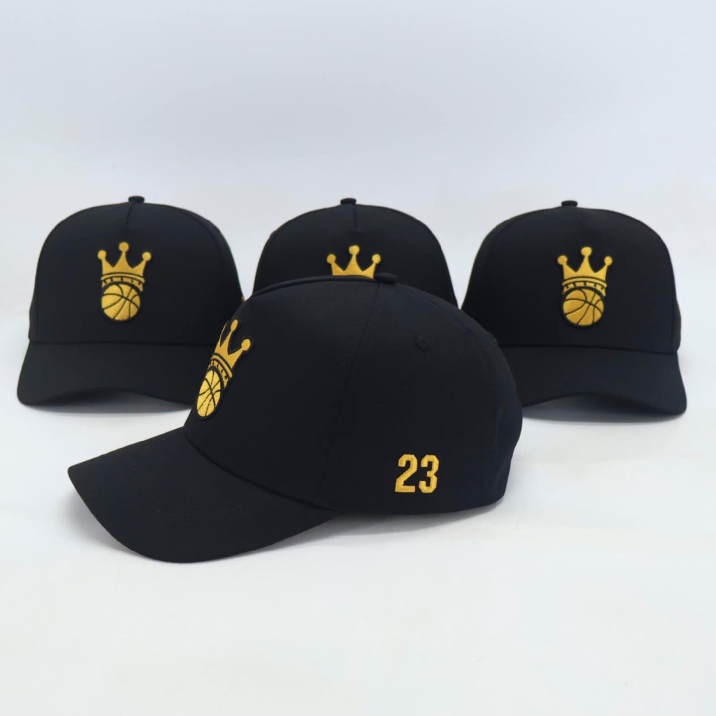 Black Snapback hat with gold ball/crown logo - side view
