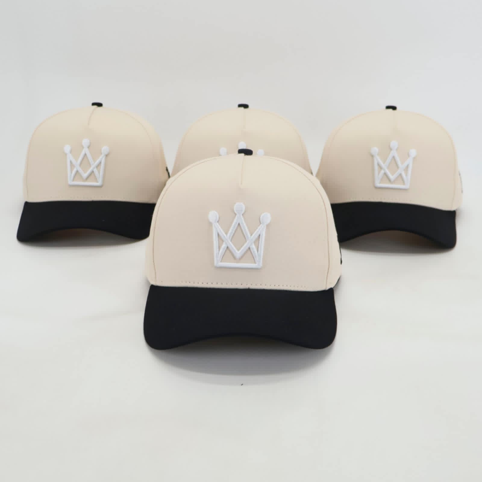 Beige and black snapback hat with white crown logo - front view