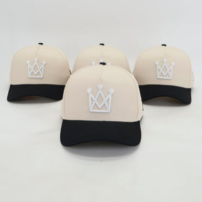 Beige and black snapback hat with white crown logo - front view