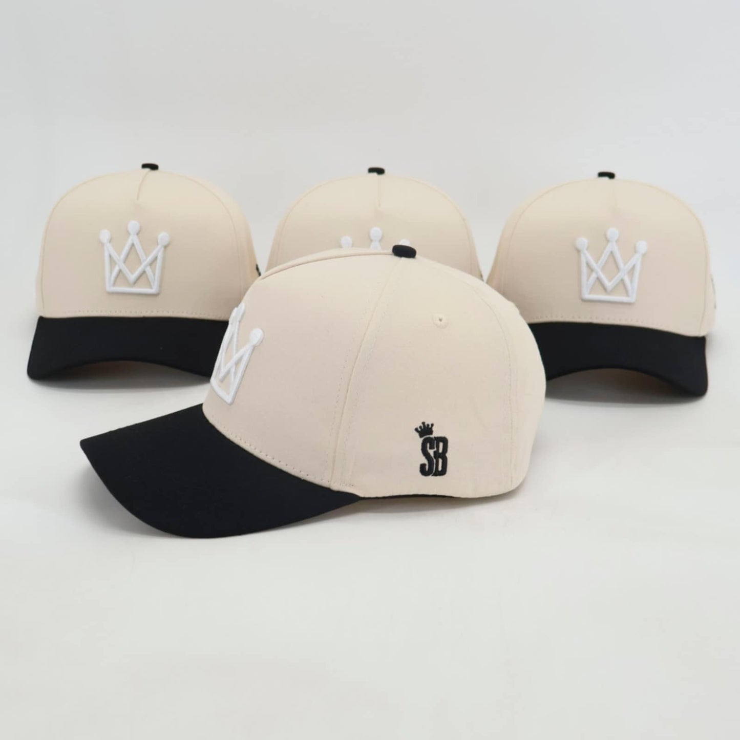 Beige and black snapback hat with white crown logo - side view