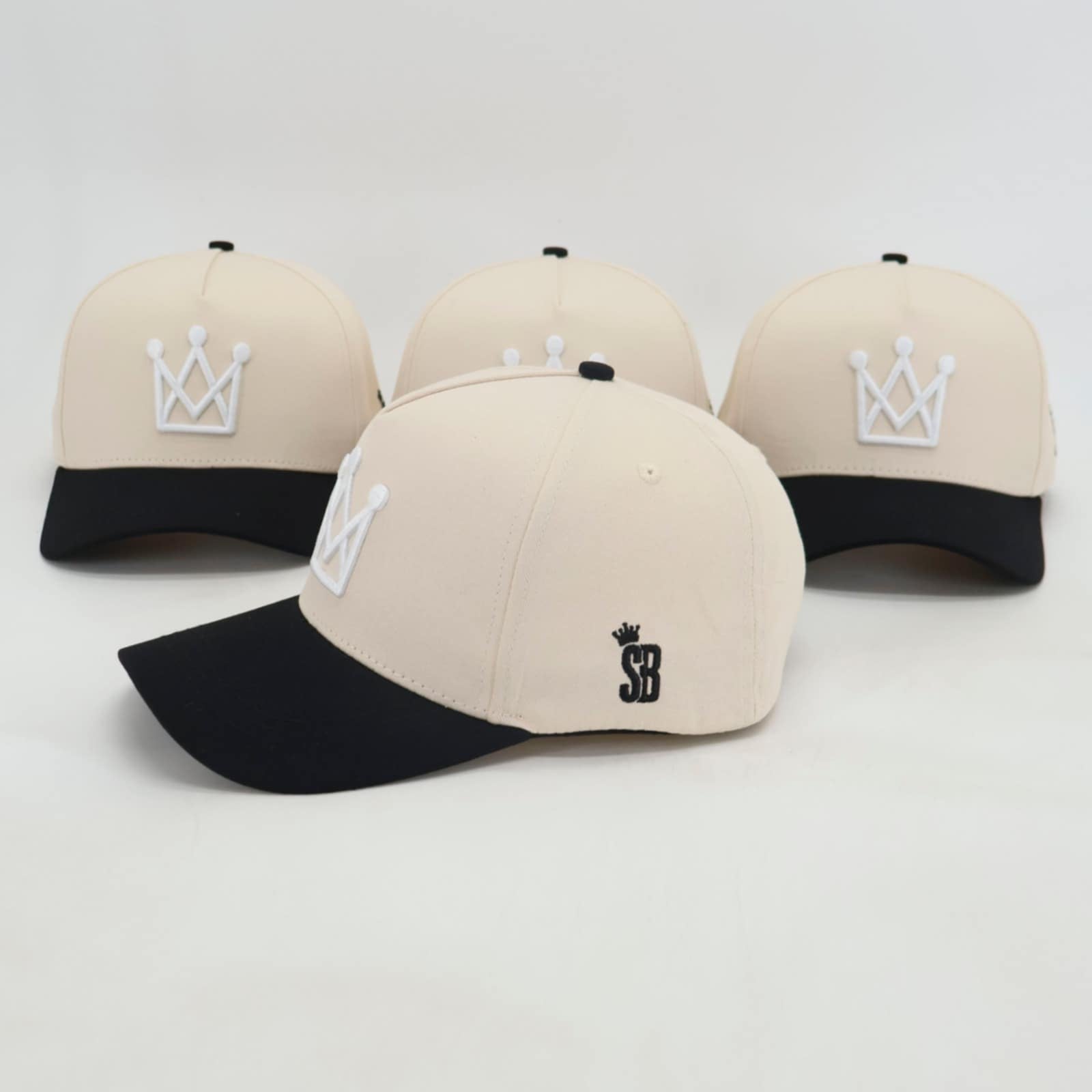 Beige and black snapback hat with white crown logo - side view